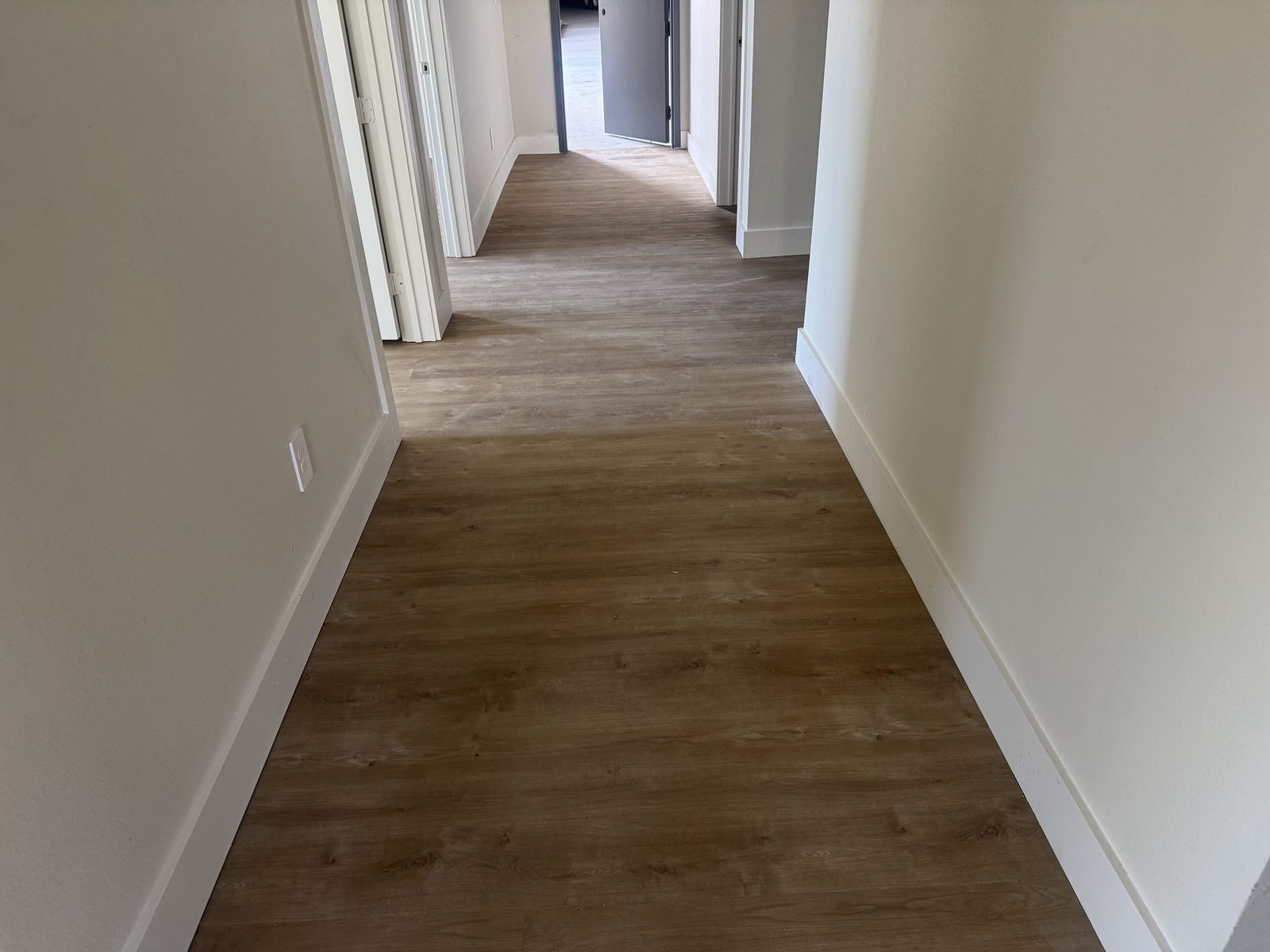 Vinyl plank flooring running the length of a hallway