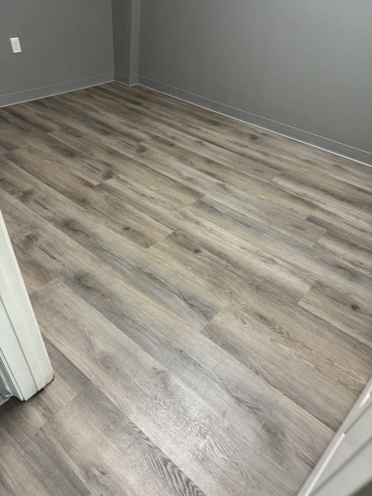 Wood-look luxury vinyl plank flooring in an open-plan room